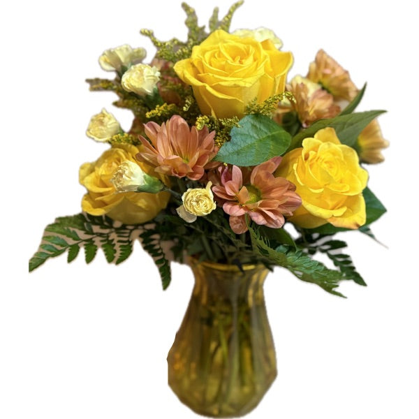 Bouquet of flowers with a sunflower, roses, and other assorted flowers in a matte autumn gathering vase 